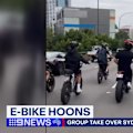 A flood of young men on e-bikes can be seen speeding over Sydney Harbour Bridge in wild new footage.
