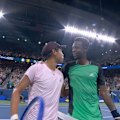 Gael Monfils and Learner Tien share an embrace at the net after their second round match at the US Open.