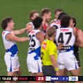 North ruckman Tristan Xerri wipes blood on Andrew McGrath after kicking a goal.