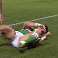 Savelio Tamale is taken off for a head injury assessment after a nasty landing when attempting to catch a high ball