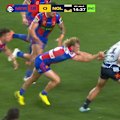 Cowboys player Heilum Luki runs over an injured Fletcher Sharpe to score North Queensland's first try.