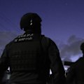 A young woman has been charged over an alleged plot to kill a high-profile member of an organised crime gang.