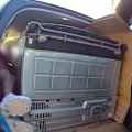 A Brisbane man has been fined more than $1000 after he was found laying down next to a fridge inside a moving car.