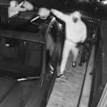 Two masked men are seen dousing cars in accelerant and setting them alight in November last year.