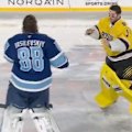 Goaltenders Andrei Vasilevskiy and Jeremy Swayman throw punches during the NHL Stadium Series between the Boston Bruins and the Tampa Bay Lightning.