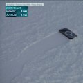 Nine's David Culbert is left puzzled after Mischa Thomas' phone falls out of her pocket on during the women's freeski halfpipe final.
