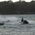 Two brave jet-ski riders have sprung into action after a houseboat caught fire on the Gold Coast.