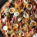 The capricciosa pizza with ham, olives, mushrooms and boiled egg.