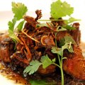 Tea-smoked quail with olive oil and roasted garlic and Sichuan pepper sauce.