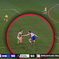 The Bulldogs avoid conceding a 50m free when Jeremy Howe has the ball knocked out of his hands by Lachlan Bramble.