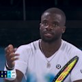 A ball kid helps up Frances Tiafoe after a brilliant rally.