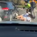 A man has allegedly carjacked a woman on a busy motorway in Sydney's west with two kids in tow.