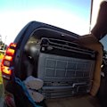 A Brisbane man has been fined more than $1000 after he was found lying down next to a fridge inside a moving car.