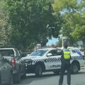 A police vehicle has been rammed by a stolen car, which went on to smash through a brick fence while trying to escape arrest.
