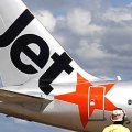 An airport worker stands in front of a Jetstar passenger plane at Avalon Airport in Melbourne.