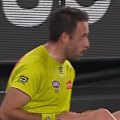 An AFL umpire has come from the ground holding his arm after an awkward landing.