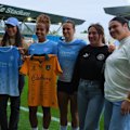Wallaroos players greet Mary Fowler after she scored in Manchester City's first match.