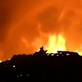 Two men have been hailed as heroes after they helped two people escape a deadly house fire during a suspected arson attack on a Gold Coast home.