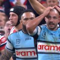 The Roosters' desperate defence stops Braydon Trindall in his tracks.
