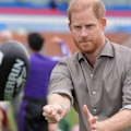 Prince Harry has tried his hand at Aussie Rules football on the second day of his Australian trip.