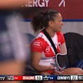 Nita Maynard-Perrin is seen using her phone on the bench during a game against the Cowboys.