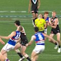An AFL umpire is in serious pain after a collision with Bulldog Ed Richards.