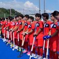 South Korean players are left puzzled as the North Korea anthem plays before their match.