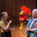 Culture reporter Nell Geraets interviews Red Fraggle from Fraggle Rock alongside puppeteer Karen Prell.