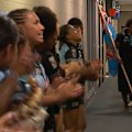 Fiji's women's players clap and sing as the men's side walks out.