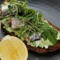 Sweet pea and feta smash on dark rye, with Spanish sardines and a lemon and herb crumb.