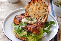 Grilled chicken thigh burger with tahini and chilli relish.