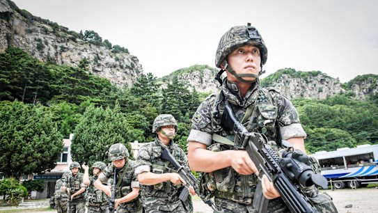 South Korean Marines patrol along the coast of the eastern island of Ulleung, South Korea, on Saturday as part of the largest-ever training to defend the island.