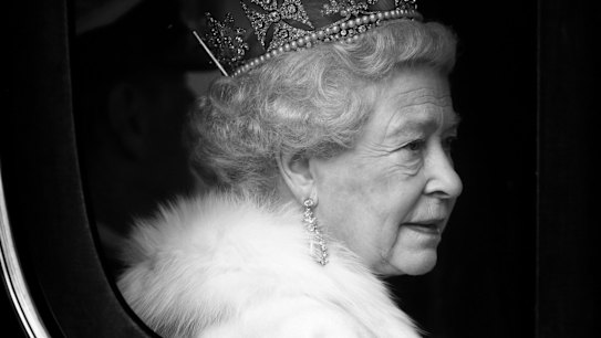 Queen Elizabeth II (wearing 'The Diamond Diadem' made by Rundell, Bridge and Rundell) travels down The Mall, from Buckingham Palace to the Palace of Westminster, in the horse drawn Irish State Coach to attend the State Opening of Parliament on December 3, 2008 in London, England. 