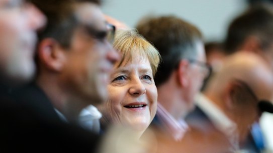 Merkel survives with minimal change to her migration policy