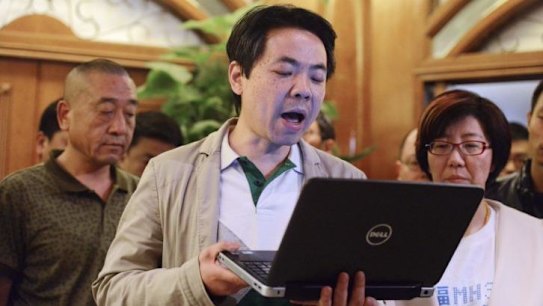 Representatives of the relatives of the passengers on the Malaysia Airlines flight MH370 announce a statement after being told the news that the plane plunged into the Indian Ocean. 