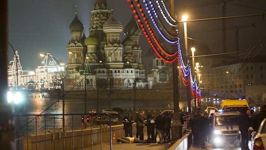 Russian police investigate the the body of Boris Nemtsov, a former Russian deputy prime minister and opposition leader at Red Square with St Basil Cathedral in the background in Moscow, Russia.