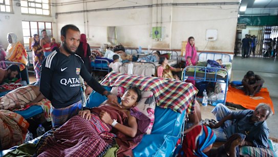 Rohingya man Hossain Ahamed points to the bullet wound his son Mohammad Touha, 16, sustained while fleeing Myanmar, as he receives treatment in Chittagong, Bangladesh.