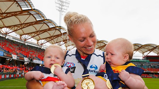 Hands full: Erin Phillips celebrates with twins Blake and Brooklyn after Adelaide's win in the AFLW grand final.