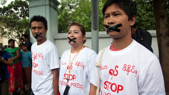 Myanmar journalist Thet Oo Maung, known as Wa Lone, right, stands in 2014 with other journalists with their mouths taped, symbolising the government's crackdown on the media.