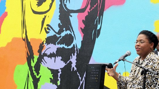 Jennifer Pinckney speaks beside an image of her late husband, the Reverend Clementa Pinckney, one of the victims of the shooting at Charleston's Emanuel AME Church.