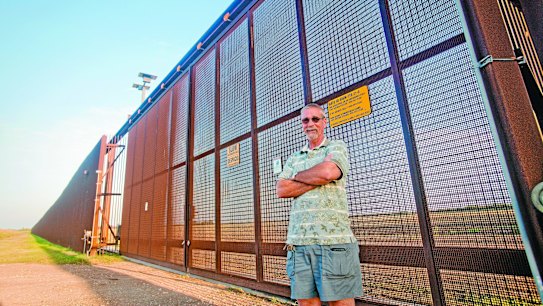 Mind the gap: Nature sanctuary manager Max Pons at a 5.5-metre-high gate along the US-Mexico border fence. Further along, a gap allows unhindered road access. 
