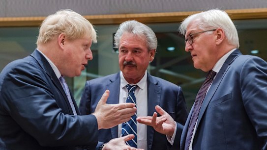 German Foreign Minister Frank-Walter Steinmeier, right, talks with British Foreign Secretary Boris Johnson, left, and Luxembourg's Foreign Minister Jean Asselborn in Brussels.