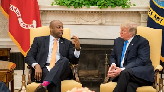 US President Donald Trump speaks to Senator Tim Scott in a White House meeting on September 13, 2017.