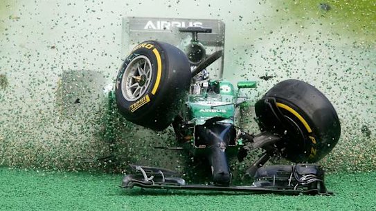 Catherham driver Kamui Kobayashi crashes out in the first corner at the 2014 Australian Grand Prix.