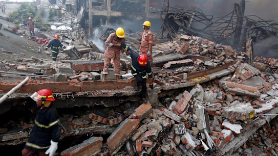 Rescue personnel work at the site of the factory fire. 