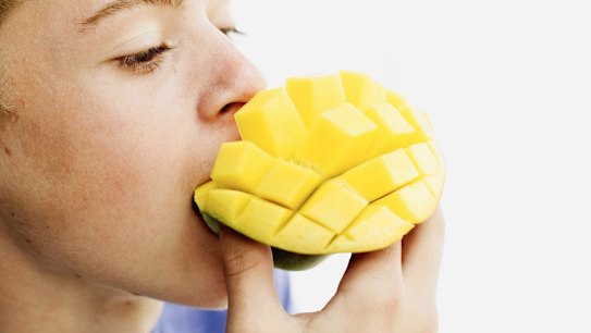 A stock image of a boy eating a cubed mango. The boy's email address could not be confirmed. 