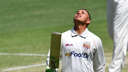Usman Khawaja looks to the sky as he celebrates his century against Victoria.