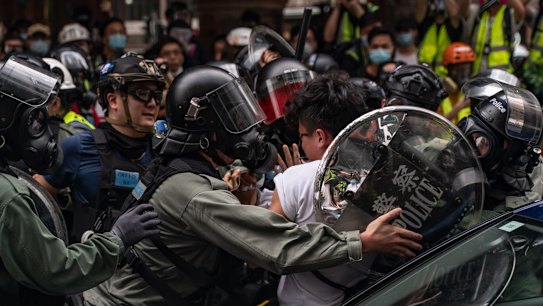 A pro-democracy supporter is detained by riot police during an anti-government rally in Hong Kong, China. 