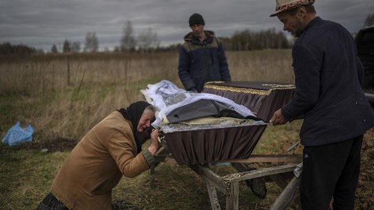 Nadiya Trubchaninova, 70, cries while holding the coffin of her son Vadym, 48, who was killed by Russian soldiers last March 30 in Bucha, during his funeral in the cemetery of Mykulychi, on the outskirts of Kyiv, Ukraine.