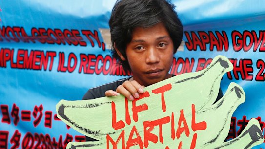 A protester holds a placard to protest the extension of martial law on Mindanao island in southern Philippines.